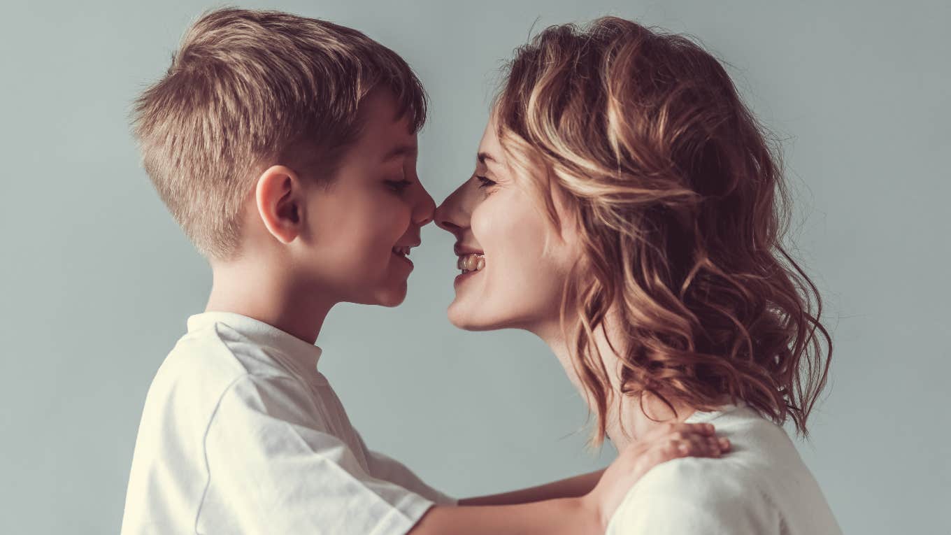 mom and her young son touching their noses and smiling