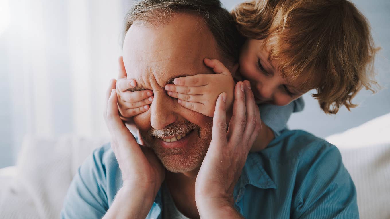 young child playing with grandfather