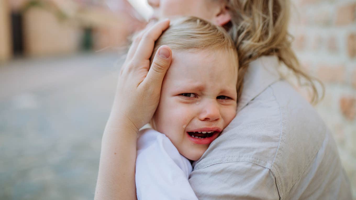 mom comforting upset son