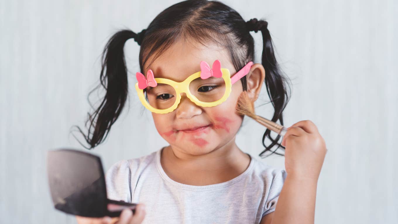 little girl playing in makeup