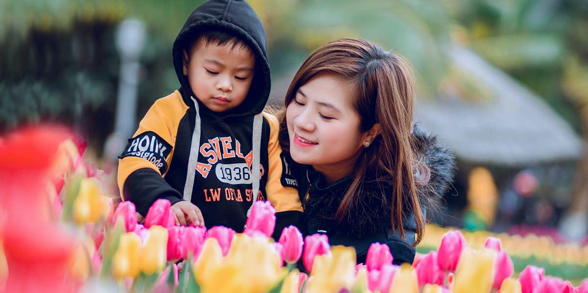 Woman Told Her Friend With A Difficult 5-Year-Old She Should 'Rehome' Him Mom and son in a flower garden