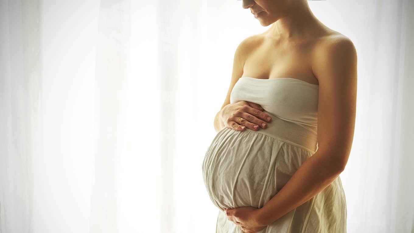 pregnant woman holding her stomach