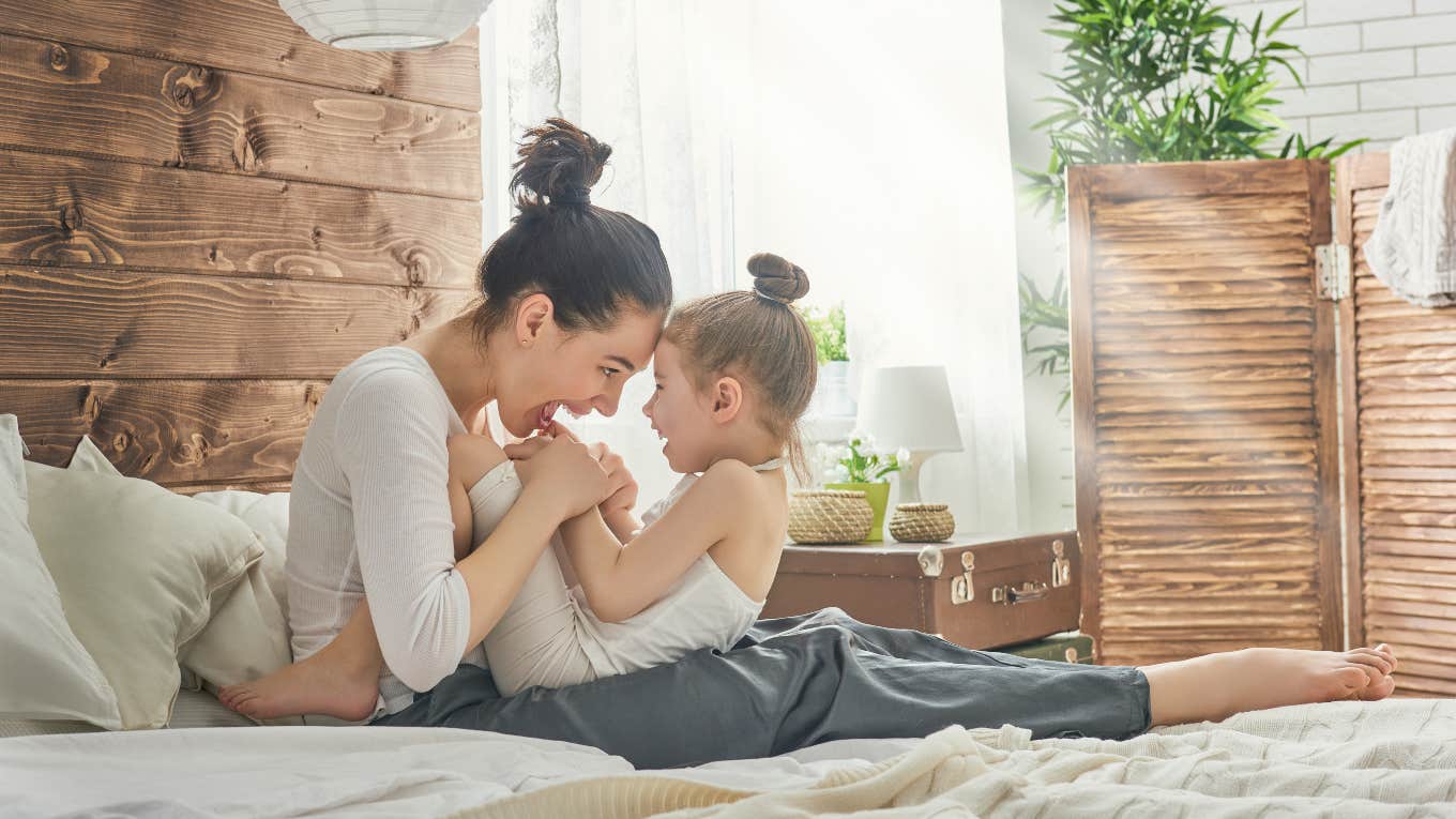 mom playing with young daughter