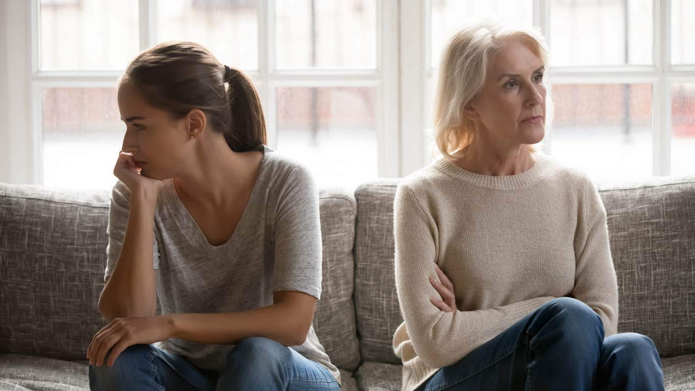 mom and adult daughter mad at each other, sitting facing opposite directions