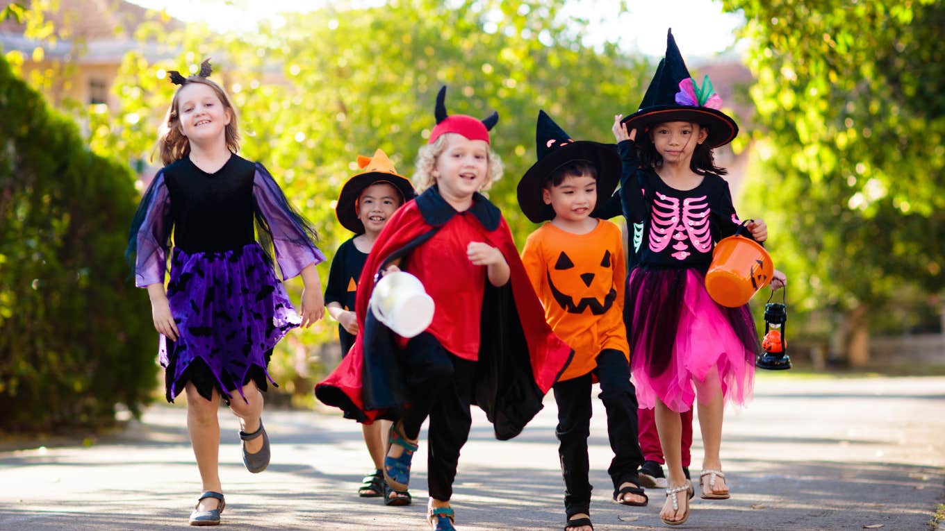 group of kids in costumes trick-or-treating