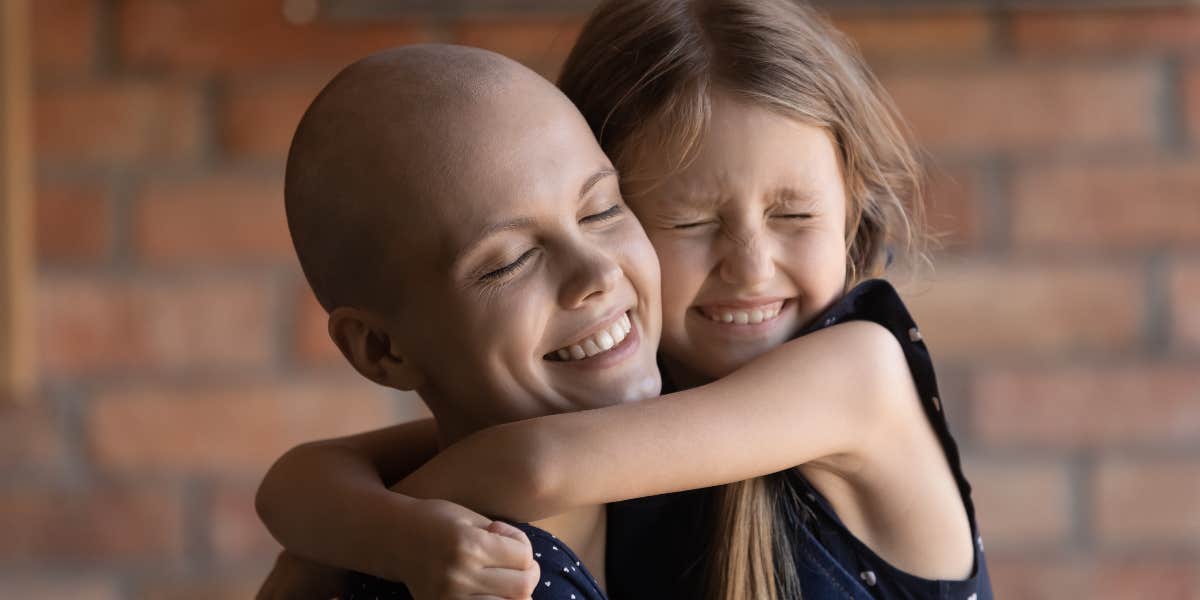 Mom with cancer hugging daughter