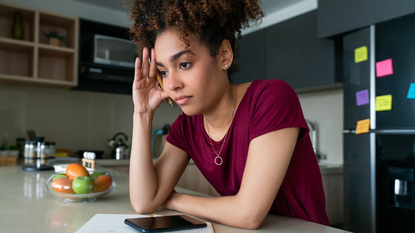 overwhelmed mom with head in hand