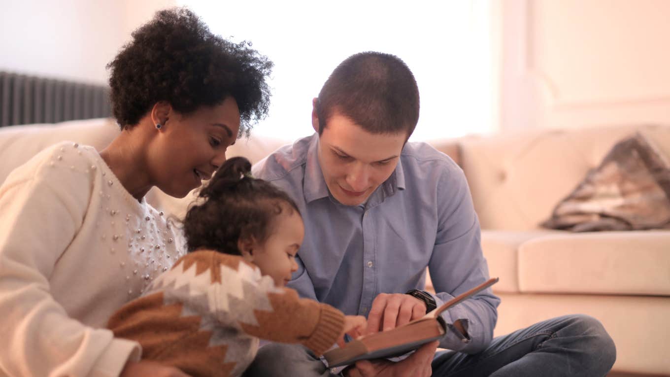 mom, dad and baby reading