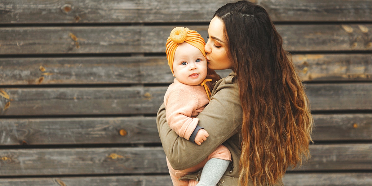 woman kissing baby