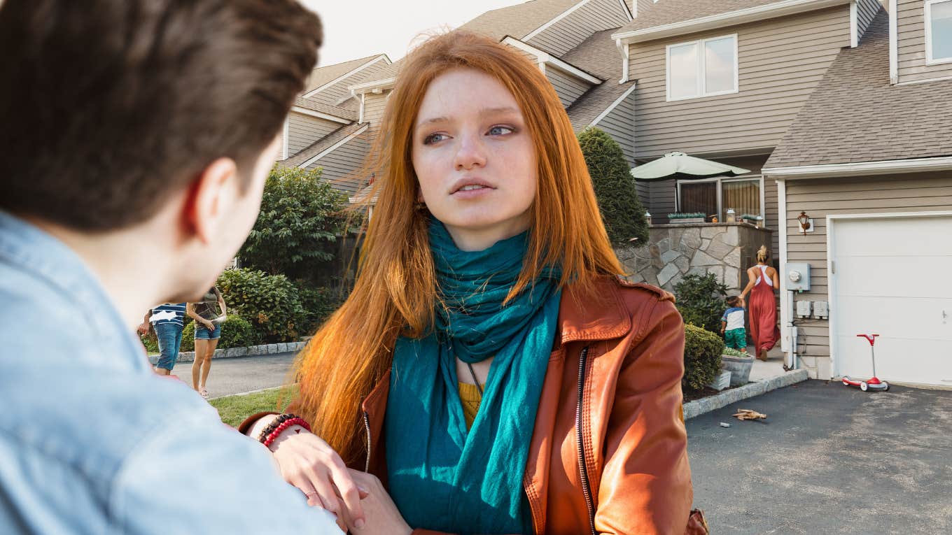 Woman reigning her anger in while addressing a intense situation with her neighbor