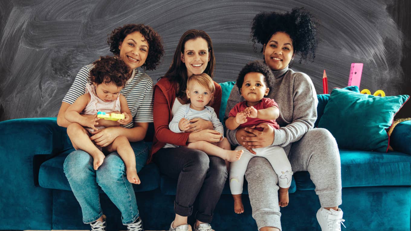 Three moms on a couch with babies on their laps