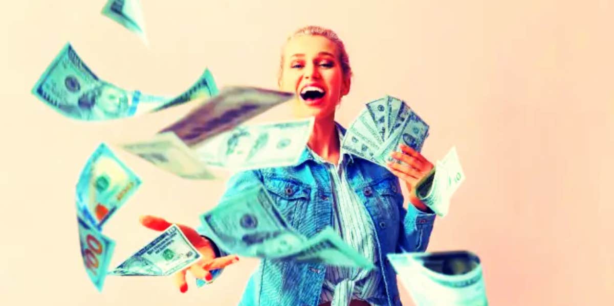 woman throwing money and laughing