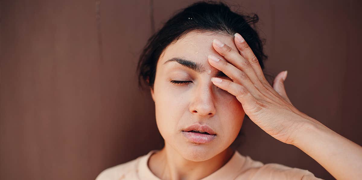 stressed out woman holding her head