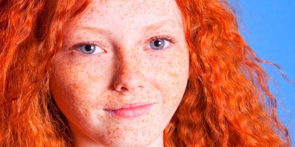 girl with bright red hair smiling