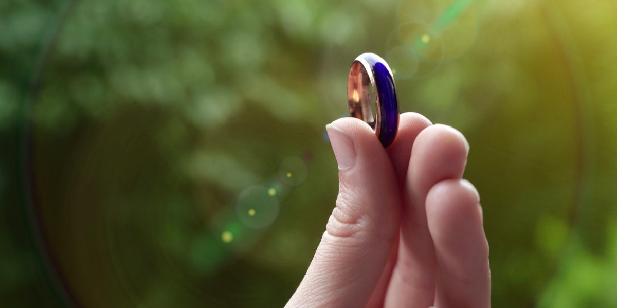 person holding up a mood ring