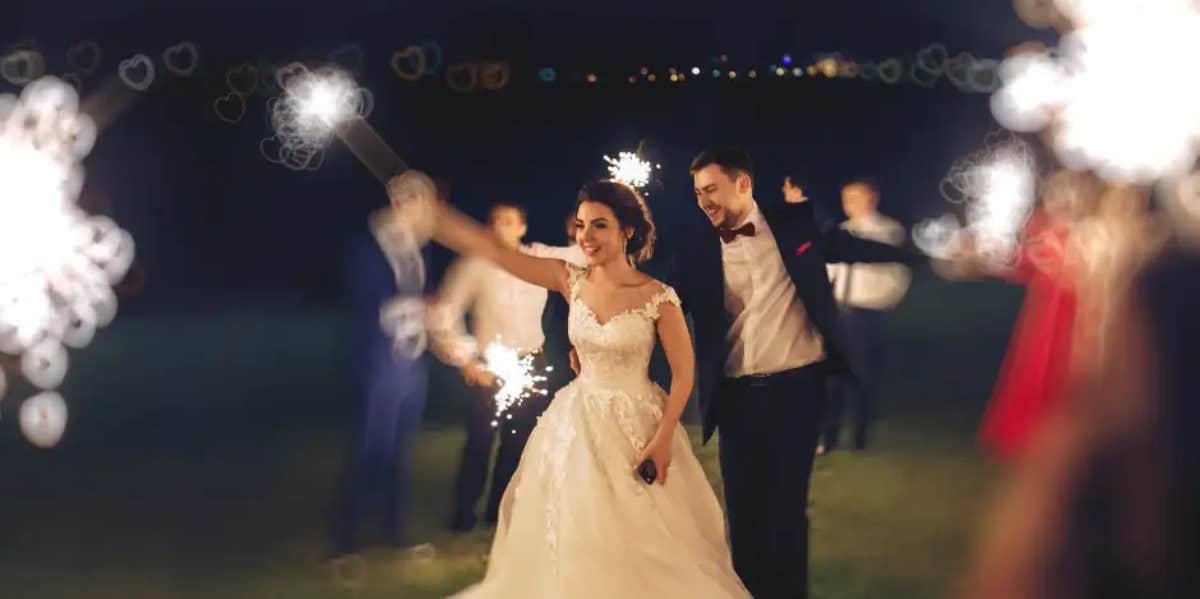 bride at wedding using sparklers