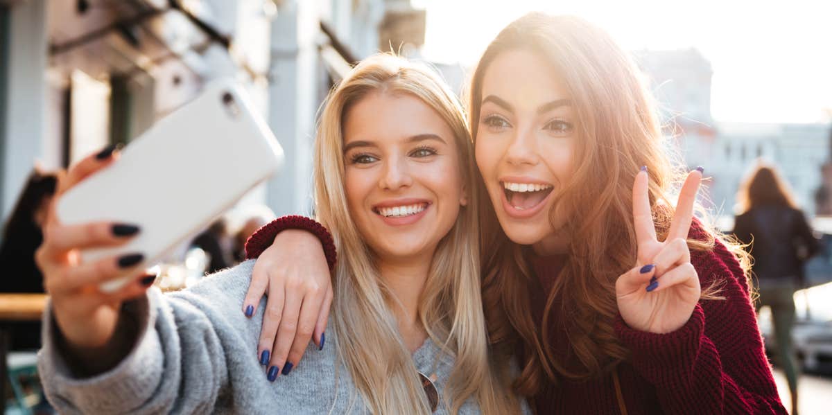 women taking selfies together