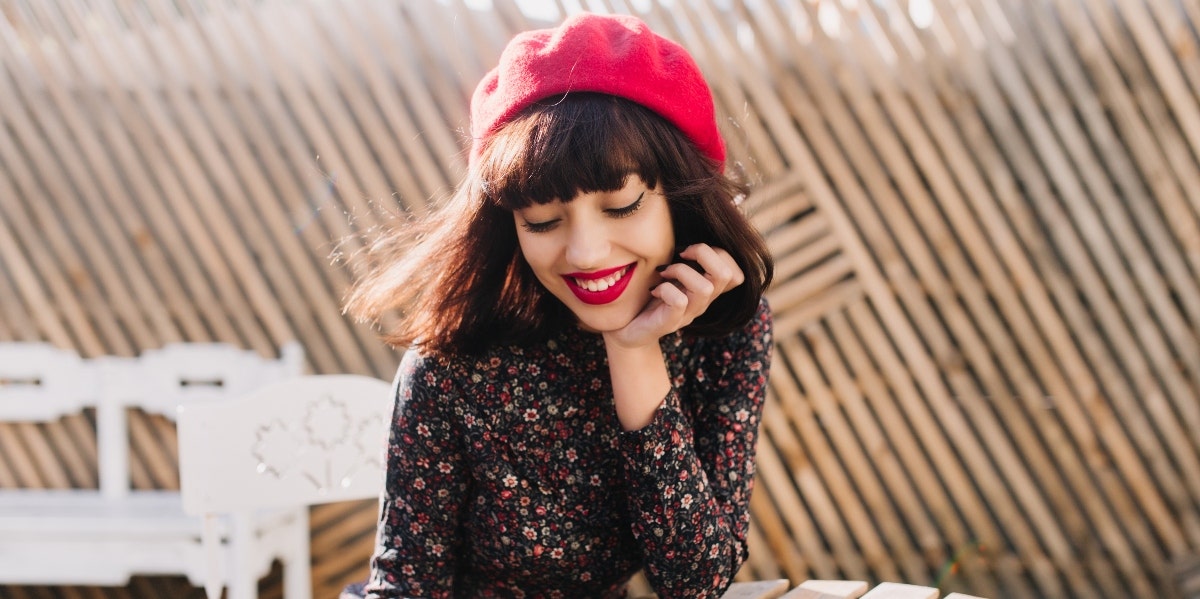 woman smiling and looking down