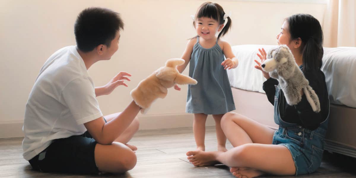 three sibling kids playing together