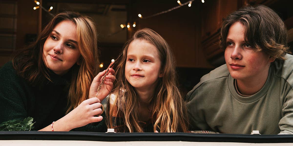 The Most Well-Liked Sibling, According To Research siblings looking out window two sisters and brother