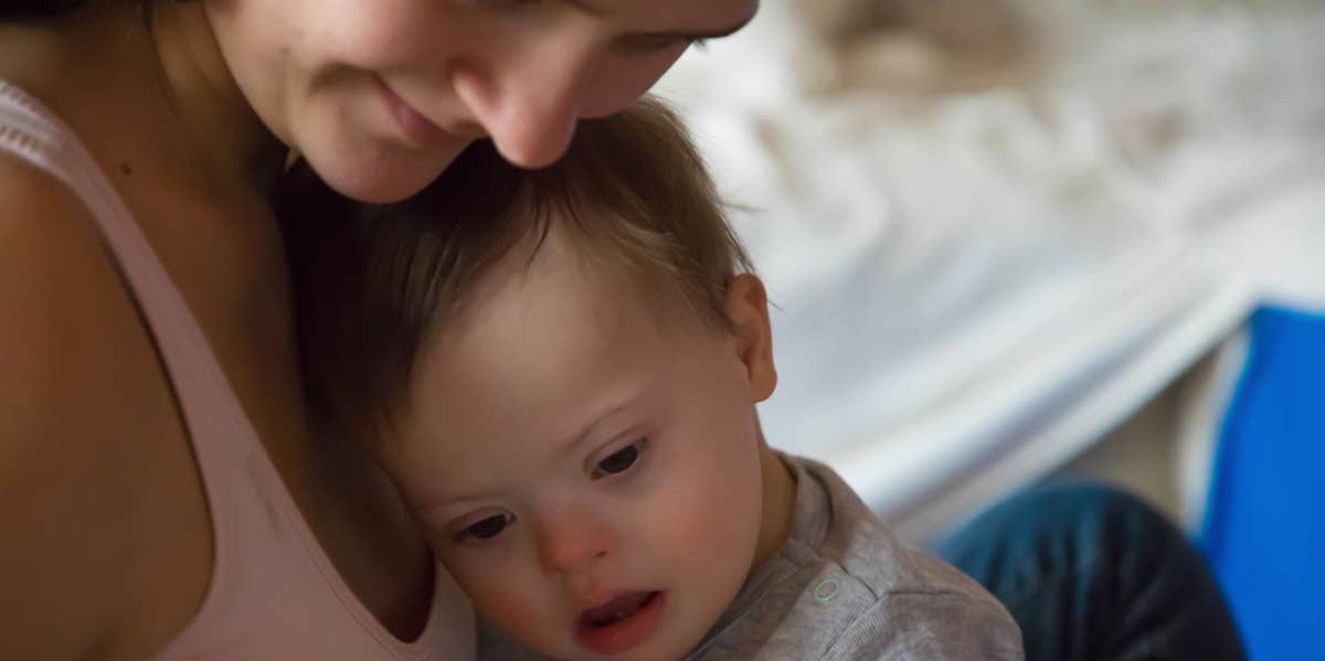 mother holding baby with down syndrome