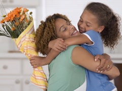 mother daughter hugging flowers
