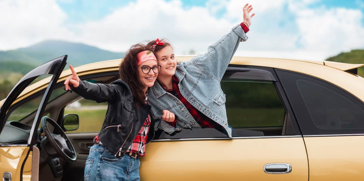 Mother and daughter by car