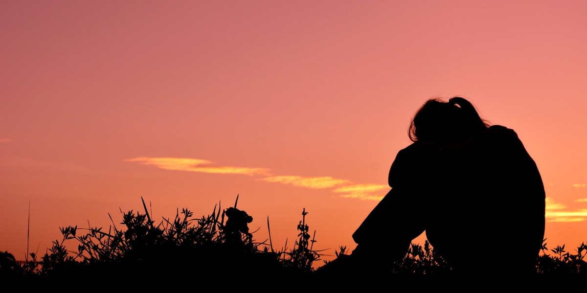 silhouette of woman in sunset