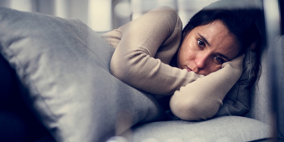 How To Move Forward After Becoming A Widow woman crying alone on couch