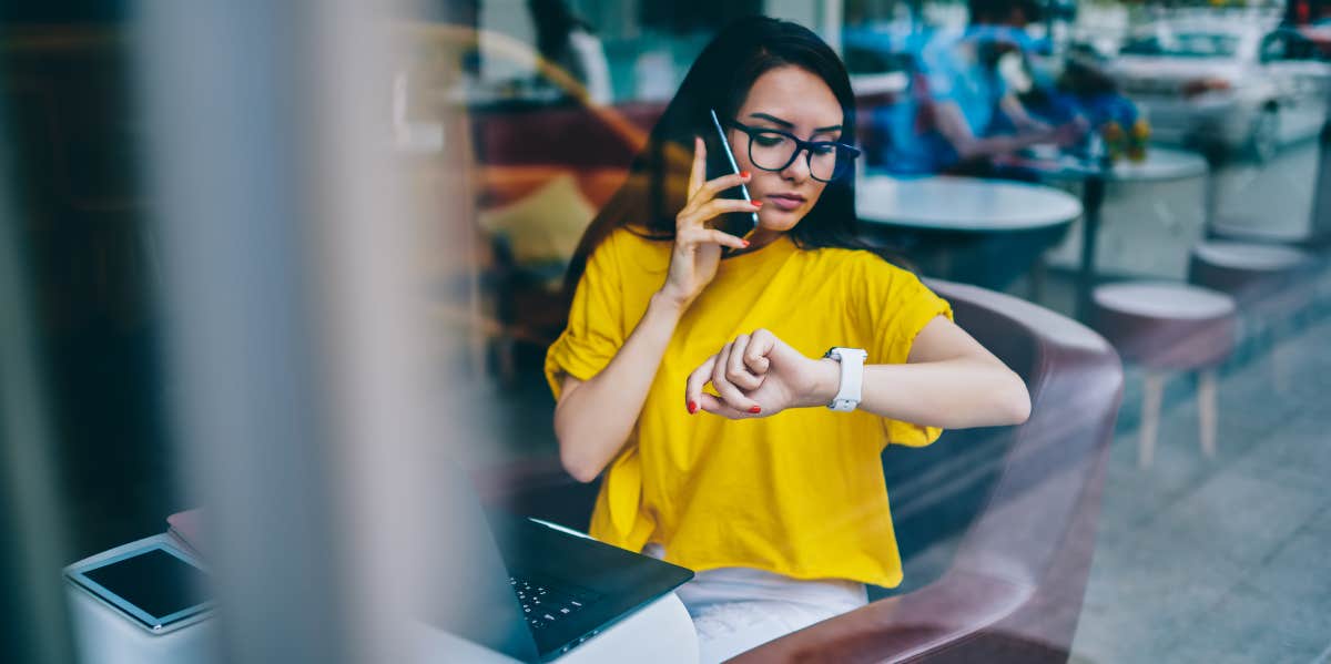 woman on the phone looking at her watch