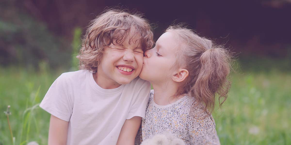 baby girl kissing a baby boy