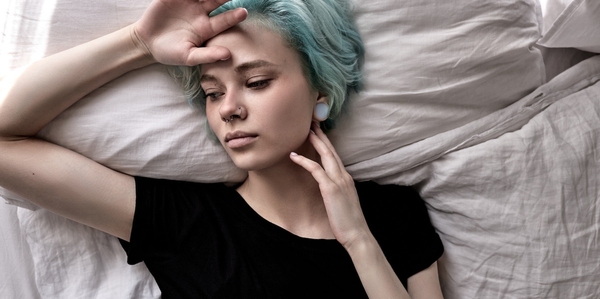 My Abusive Relationship Is Over, So Why Do I Still Behave Like a Victim? sad woman laying in bed