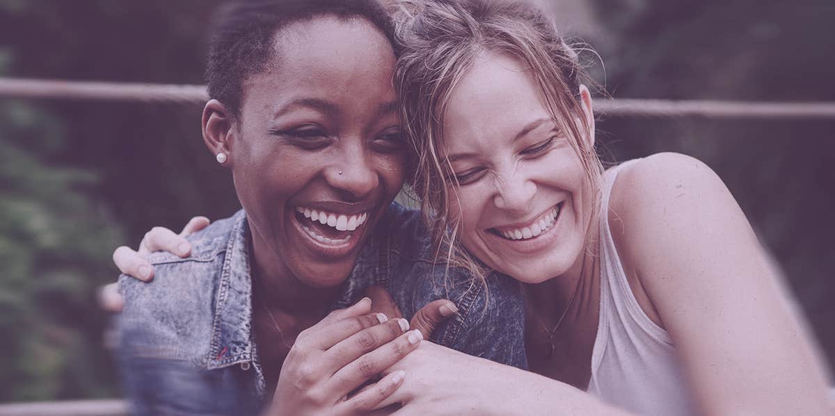 two woman smiling at each other