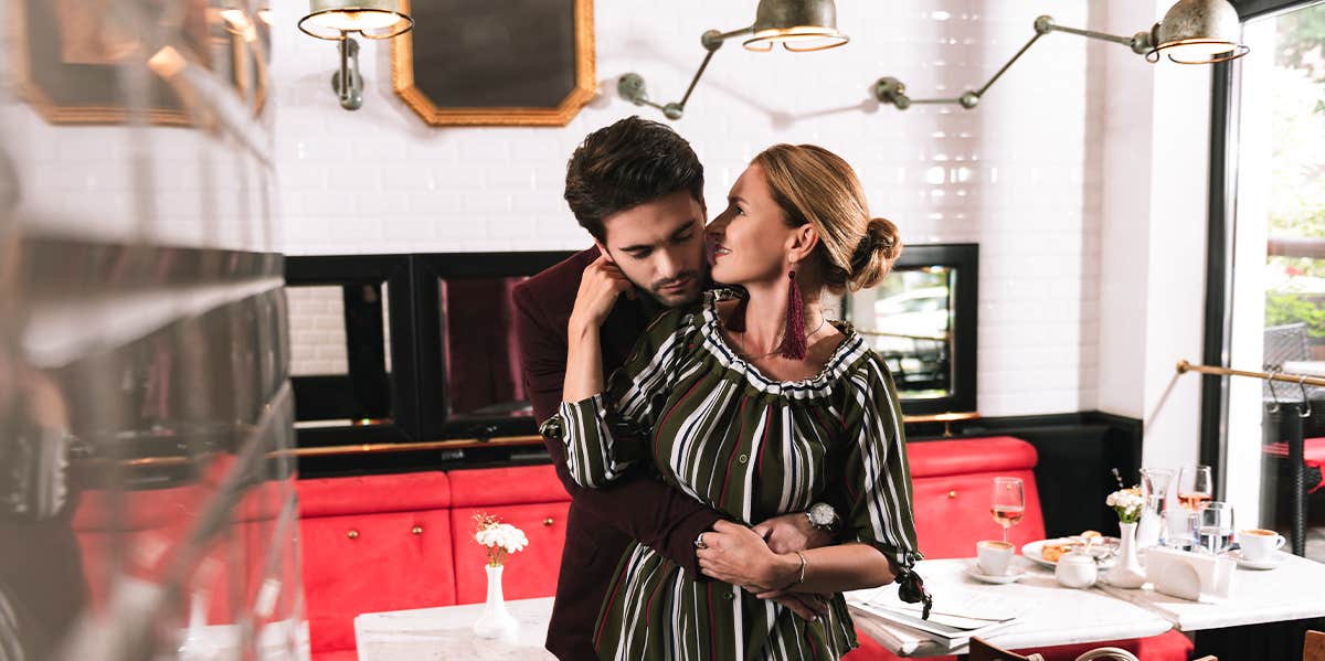 woman and man hugging in restaurant 