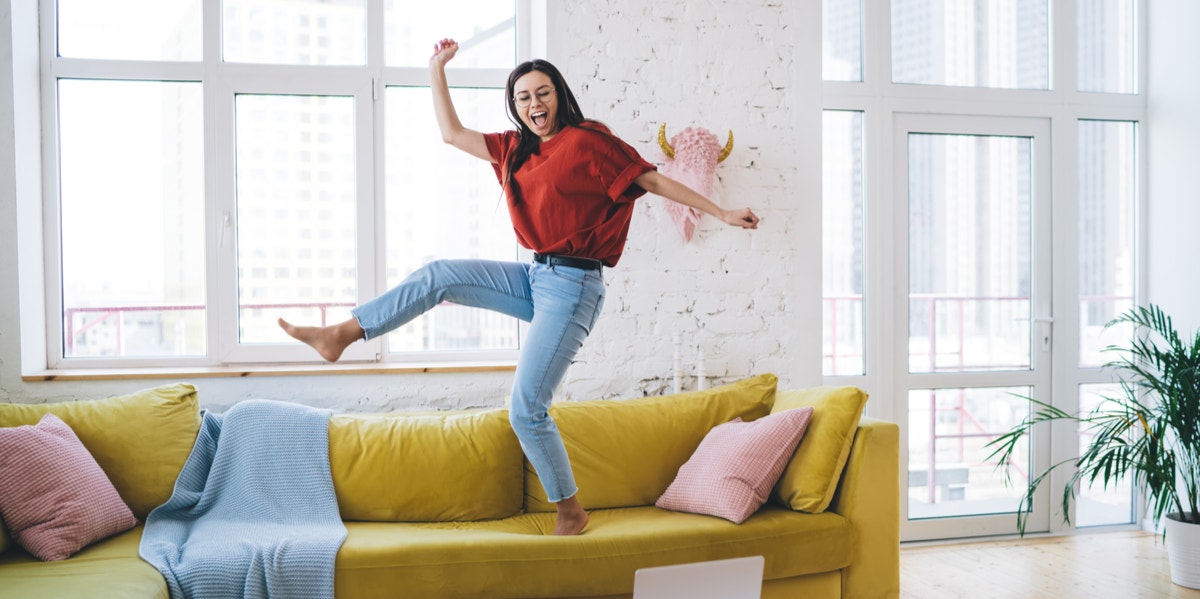 woman jumping on couch