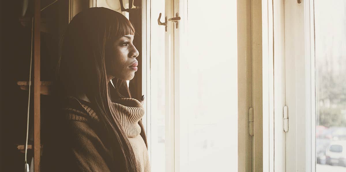 woman looking out window