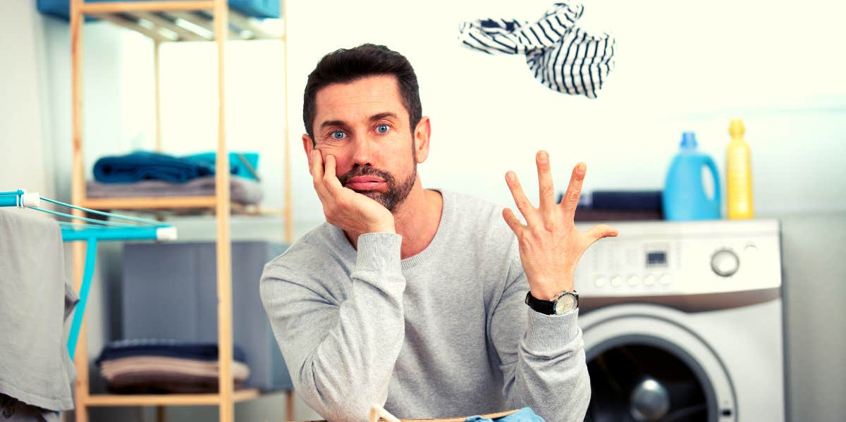 uncaring husband in the laundry room tossing up a sock