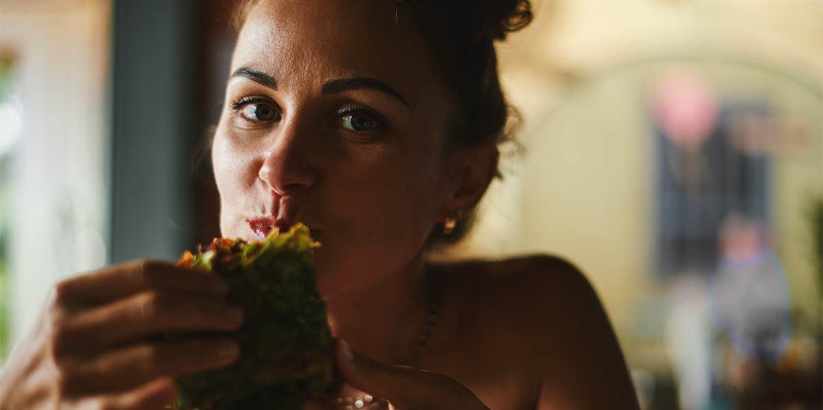 woman eating wrap