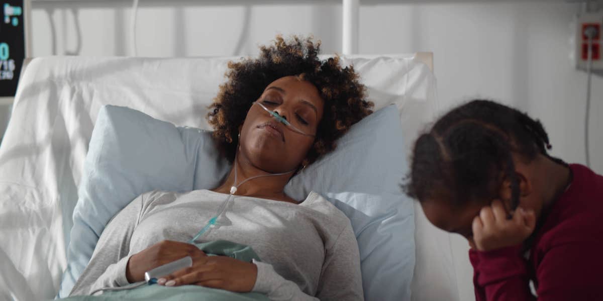 My Mom Had A Stroke: The Horrifying Reality Of Parenting Your Parent woman in bed with caretaker
