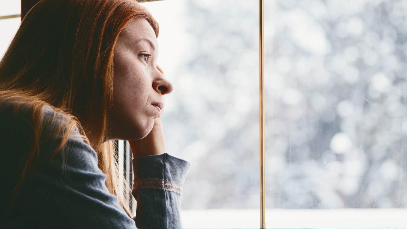 Woman looking out of window