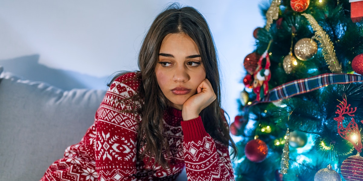 sad woman near christmas tree