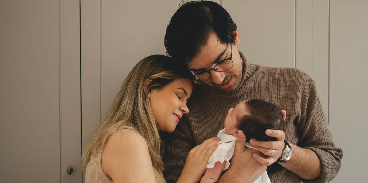 Parents holding newborn baby