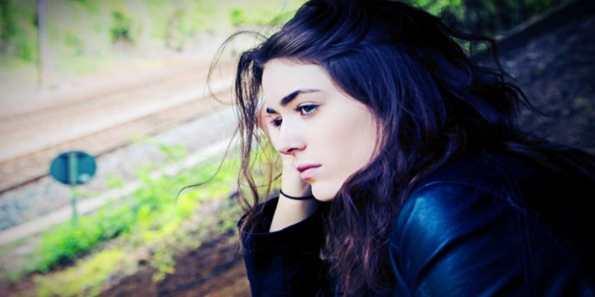 The Top 11 Signs Of A Cheating Narcissist — And How To Catch Them In The Act sad woman leaning over elbow on leg thinking