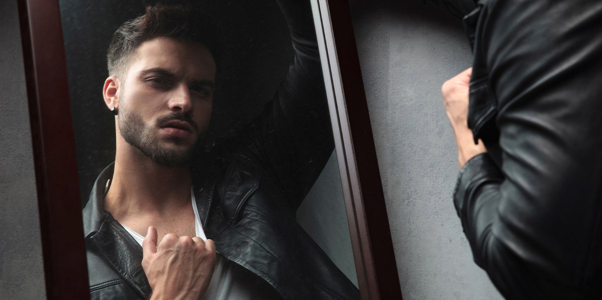 How To Spot A Narcissist With These 9 Behaviors man looking in mirror