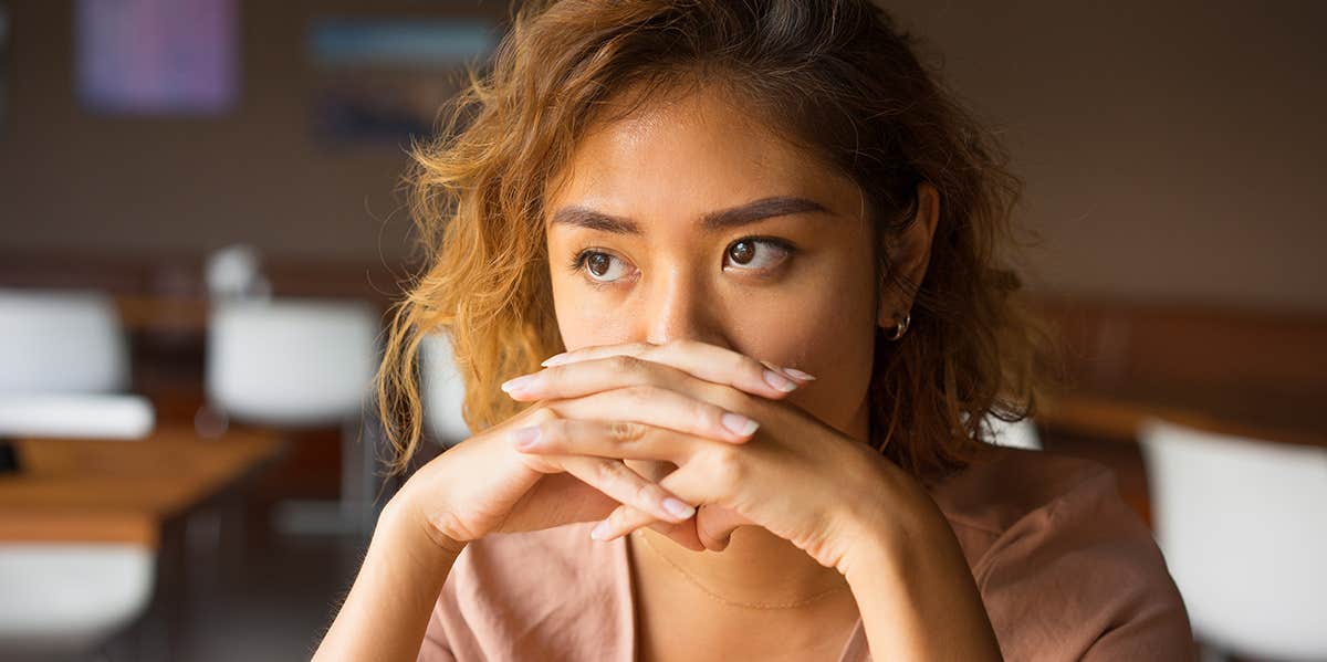 12 Devastating Ways Your Narcissistic Mother Lied To You About Who You Are woman with hands clasped looking distraught