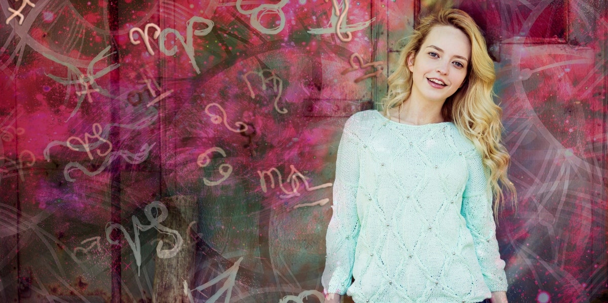 natal charts woman standing by wall with astrology signs