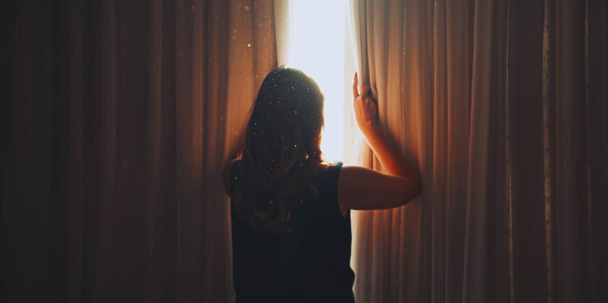 How A Near-Death Experience Reminded Me That 'Slow And Steady Wins The Race' woman opening curtains