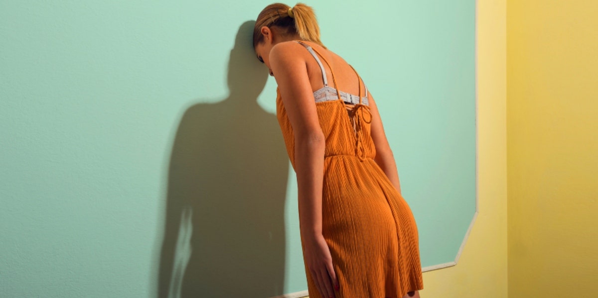 woman leaning against wall