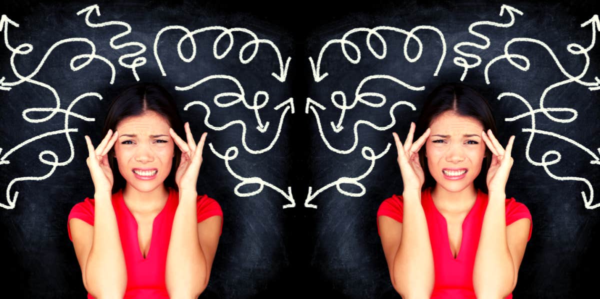 woman wincing with squiggled lines on chalkboard behind her