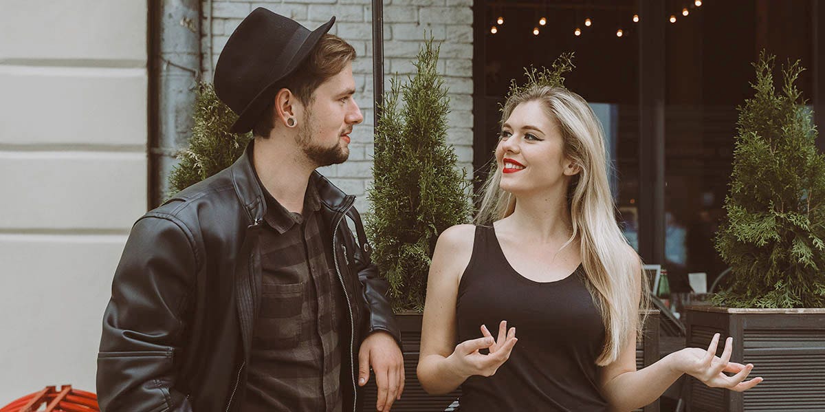What Happened When I Tried 'Negging' Guys To Get A Date woman and man in black talking